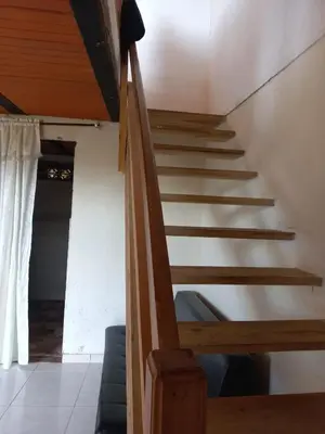 a staircase in a house with a wooden ceiling at Cabaña Noche De Luna in Jardin