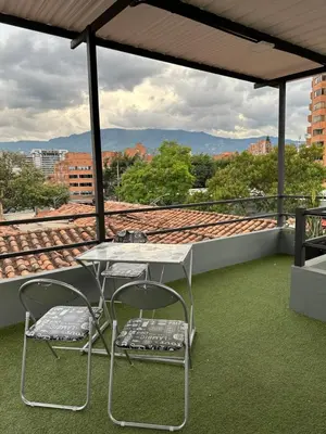 a table and two chairs on a roof at Aparta estudio amoblado Medellin, San joaquin in Medellín
