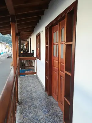 a hallway of a house with a door and a tile floor at dulce estancia in Jardin