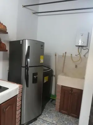 a kitchen with a stainless steel refrigerator and a sink at dulce estancia in Jardin