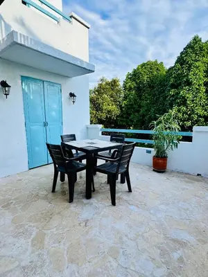 a table and chairs sitting on a patio at Cabaña Villa Jardín - Aldea Doradal - Santorini Colombiano in Doradal