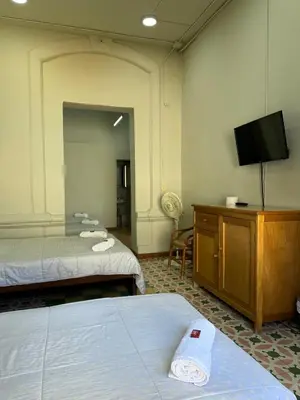 a room with two beds and a flat screen tv at Del Rocío Alojamiento -ANDES in Los Andes