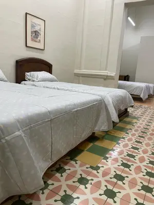 two beds in a room with a colorful floor at Del Rocío Alojamiento -ANDES in Los Andes