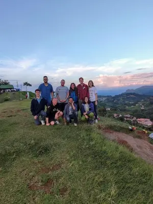a group of people posing for a picture on a hill at Parcerito's Hostel in Jericó