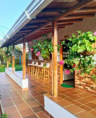 a patio with tables and potted plants at Samaria, un lugar para descansar y disfrutar in Santa Elena