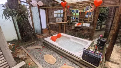 an outdoor bath tub with red hearts in it at BioHotel Ecohouse in Guarne