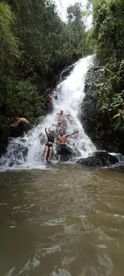 a group of people in front of a waterfall at BioHotel Ecohouse in Guarne