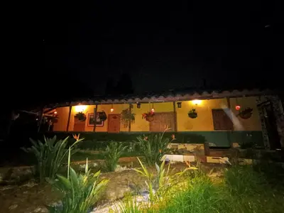 a house at night with lights in front of it at BioHotel Ecohouse in Guarne