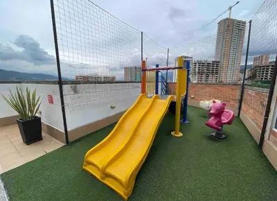 a playground with a yellow slide on a balcony at Piso13 Sabaneta, apartment, Parking, Pool & with club in the sky! in Sabaneta