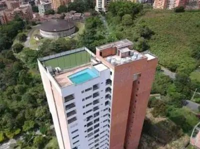an aerial view of a building with a swimming pool on top at Piso13 Sabaneta, apartment, Parking, Pool & with club in the sky! in Sabaneta