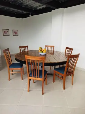 a wooden table with chairs and a bowl of fruit on it at El Espume de San Juan by JR in Guatapé