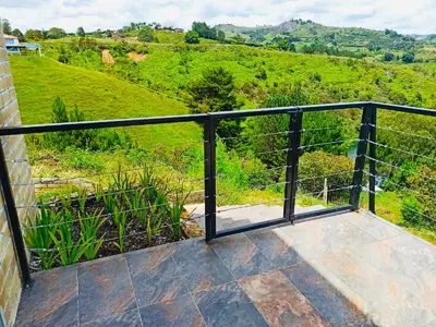 a balcony with a view of a hill at El Espume de San Juan by JR in Guatapé