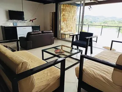 a living room with a bed and a couch and a table at El Espume de San Juan by JR in Guatapé