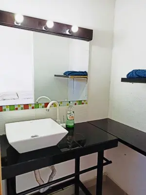 a bathroom with a sink and a mirror at El Espume de San Juan by JR in Guatapé