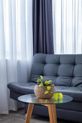a living room with a blue couch and a table at Lexum by Bernalo Hotels in Medellín