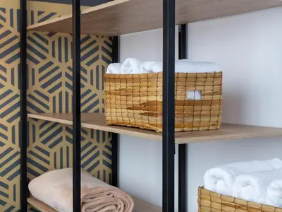 a room with a shelf with baskets and towels at Lexum by Bernalo Hotels in Medellín