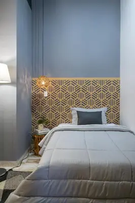 a bedroom with a large bed and a wall at Lexum by Bernalo Hotels in Medellín