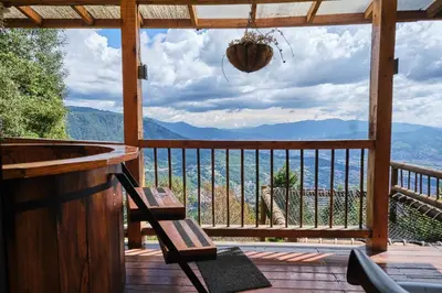a porch with a view of the mountains at Skyline Ecoliving Santa Elena in Santa Elena