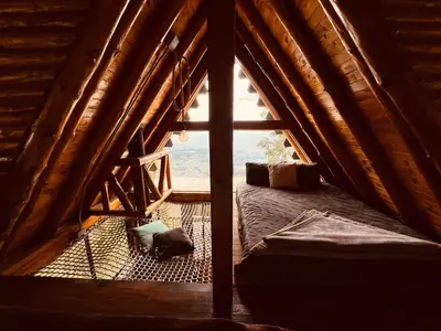 a cat laying on the floor in a room with a window at Skyline Ecoliving Santa Elena in Santa Elena