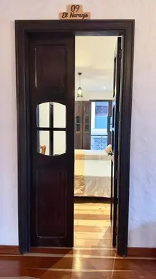 a door leading into a room with a bedroom at Hotel Boutique La Leyenda 1860 in Salamina