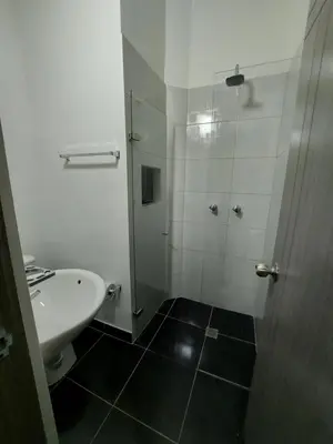 a bathroom with a shower and a sink at Aparta estudio amoblado 2 Medellin, San joaquin in Medellín