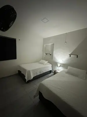 a bedroom with two beds and a flat screen tv at Aparta estudio amoblado 2 Medellin, San joaquin in Medellín