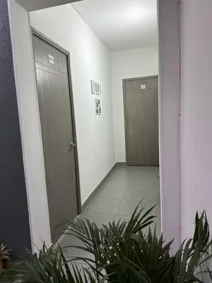 an empty hallway with two doors and plants at Aparta estudio amoblado 3 Medellin, San joaquin in Medellín
