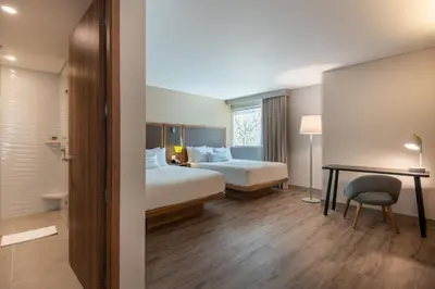 a hotel room with a bed and a desk at Fairfield by Marriott Medellin Sabaneta in Medellín