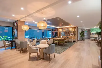 a restaurant with tables and chairs in a building at Fairfield by Marriott Medellin Sabaneta in Medellín