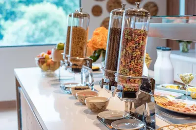 a buffet with many different types of food in glass containers at Fairfield by Marriott Medellin Sabaneta in Medellín