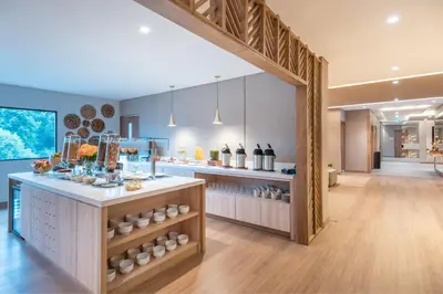 a large kitchen with a counter and a room at Fairfield by Marriott Medellin Sabaneta in Medellín