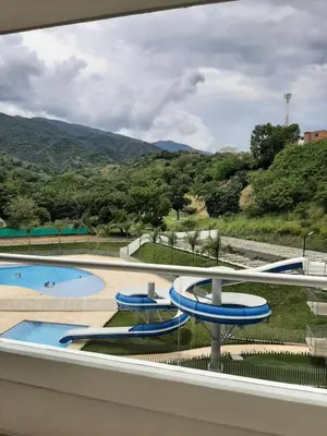 a view of a swimming pool from the balcony of a resort at Apartamento Citadela Di Sole Santa fe De Antioquia in Santa Fe de Antioquia