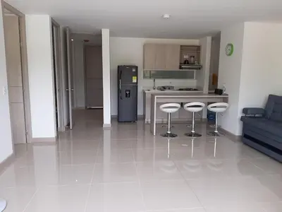 a kitchen with a counter and stools in a room at Apartamento Citadela Di Sole Santa fe De Antioquia in Santa Fe de Antioquia