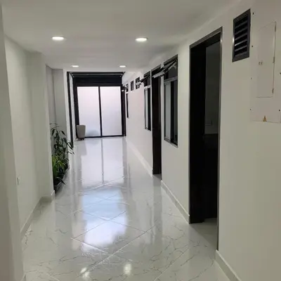 an empty hallway with white walls and a tile floor at Nómada Hospedaje in San Rafael