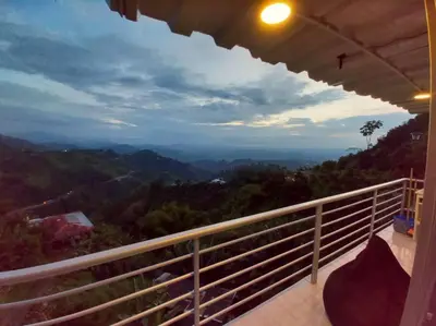 a balcony of a house with a view of the mountains at Apartamento Campestre y Turístico con Garaje y Mirador in Manizales