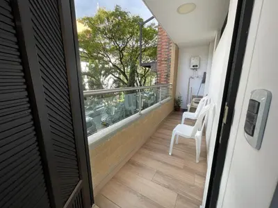 an open door to a balcony with a view of a balcony at En Laureles con ascensor , balcón y muy bien ubicado en laureles Medellín , EL BARRIO MAS COOL DEL MUNDO in Medellín