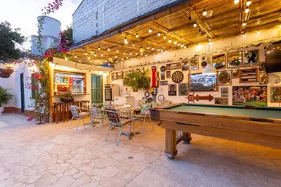 a pool table in the middle of a patio at Entre Palmas Casa Hotel in Santa Fe de Antioquia