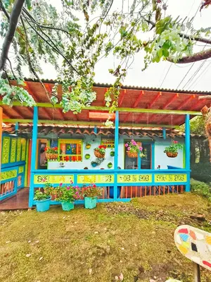 a colorful building with flowers in a yard at Galilea in Santa Elena