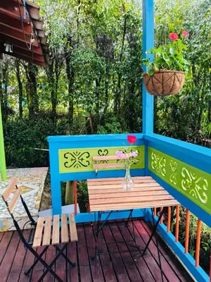 a table and bench on a porch with a flower pot at Galilea in Santa Elena