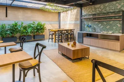 a restaurant with tables and chairs and plants at Loft 43 in Medellín