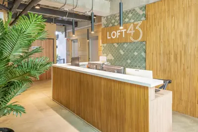 an office lobby with a reception desk and a sign at Loft 43 in Medellín