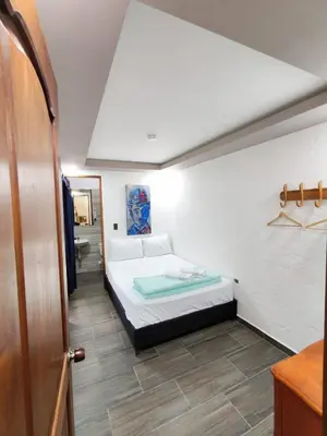 a small bedroom with a bed and a bathroom at Apartamento turístico jardín Antioquia in Jardin