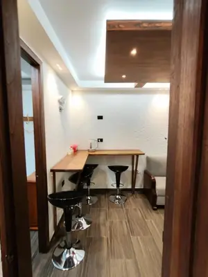 a kitchen with a table and stools in a room at Apartamento turístico jardín Antioquia in Jardin