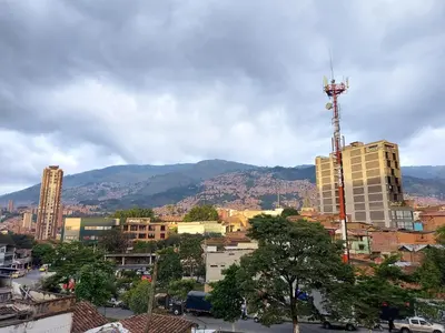 a view of a city with mountains in the background at P.H Downtown - Tranvía in Medellín