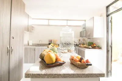 a kitchen with two baskets of fruit on a counter at Bosques de la Pradera in Manizales