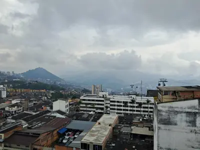 a city with buildings and a mountain in the background at Hostal Mirador Andino in Manizales