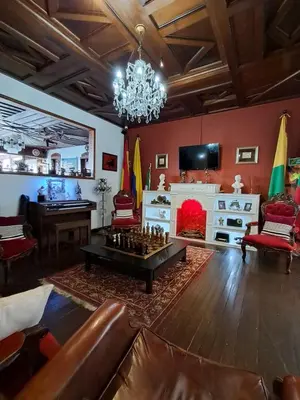 a living room with a chess table and a fireplace at Hostal Mirador Andino in Manizales