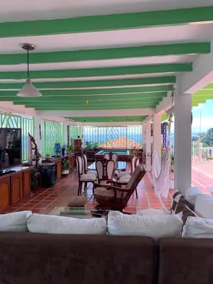 a living room with a couch and a table and chairs at Villa NiNa in Manizales