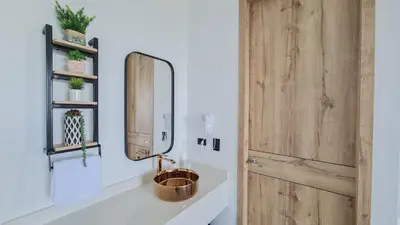 a bathroom with a sink and a mirror at Hotel Arbóreo Doradal in Doradal