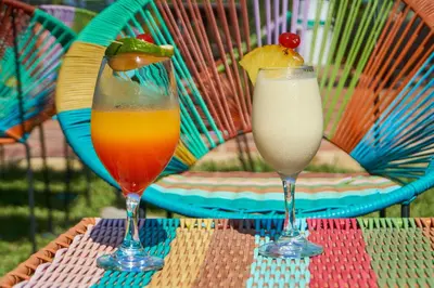 two glasses of juice and a drink on a table at Hotel Arbóreo Doradal in Doradal